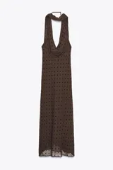 Vestido largo marrón con lunares negros, cuello halter ajustable, escote drapeado, espalda descubierta con tira ajustable y cierre lateral con cremallera oculta.