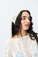 Pañuelo de tejido crochet color crema.