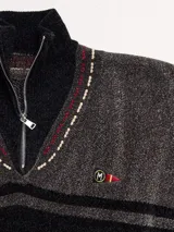 Sweater azul con cuello alto con medio cierre, textura tipo terciopelo y puños acanalados.