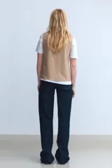 Top gris de cuello alto y sin mangas.