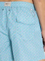 Short de baño celeste con estampado de caballitos de mar rosados. Tiene cintura elástica con cordón ajustable, bolsillos laterales y traseros.