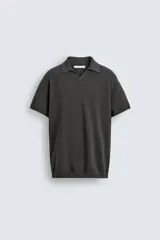 Jersey de punto color verde oliva, de calce relajado (relaxed fit), con cuello solapa y abertura frontal en forma de V. Es de manga corta y presenta acabados en rib en puños y ruedo.