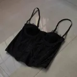 Corset negro de encaje con copas preformadas, breteles finos regulables y ballenas de soporte.