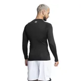 Remera deportiva azul de manga larga con orificio para el pulgar y logo de la marca en el pecho.