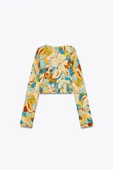 Top corto de punto con estampado floral, cuello redondo, manga larga y cierre frontal con botones.