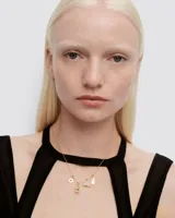 Dije colgante con forma de margarita, con centro dorado y pétalos plateados.