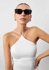 Lentes de sol negros con forma cat-eye, fabricados con materiales reciclados.