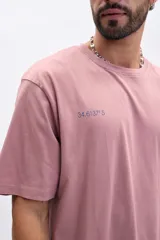 Remera manga corta color rosa con estampa azul en la espalda que dice 'I OWN SWAGGER' y coordenadas geográficas.