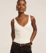 Blusa blanca de punto acanalado con escote en V y espalda descubierta.