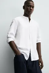 Camisa color beige claro de lino y algodón, corte relaxed fit, cuello mao, manga larga con puños abotonados y cierre frontal con botones. Marca Zara.