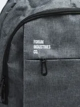 Mochila negra con logo Forum Industries Co. estampado en blanco. Cuenta con múltiples compartimentos con cierre, dos bolsillos laterales de red y asa de mano acolchada.
