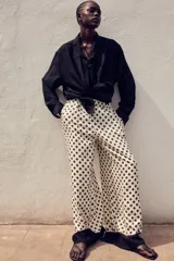 Pantalón de corte holgado con cintura elástica de tiro alto, bolsillos laterales discretos y piernas amplias.