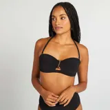 Top de bikini bandeau negro con textura y detalle de pedrería dorada en el centro.