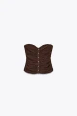 Top bustier marrón de lino con escote recto, hombros descubiertos, detalle de frunces, falsos botones delanteros y nido de abeja elástico en la espalda.