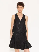 Minifalda negra con lentejuelas y volados en el ruedo.