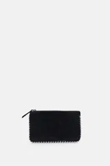 Bolso bandolera negro con tachas plateadas en los bordes. Tiene cierre de cremallera y asa de cadena extraíble.
