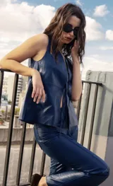 Chaleco azul de cuero ovino con escote en V y lazos de ajuste frontales.