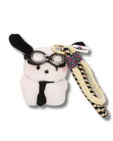 Llavero con forma de perro de peluche blanco con orejas negras, gafas de aviador y corbata negra. Incluye una cuerda trenzada beige y azul con detalles en rosa y verde.