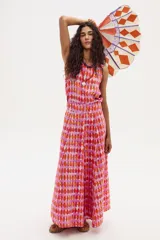 Falda larga de lino con estampado de rombos en tonos rosados y anaranjados. Es de estilo portafolio, con cintura elástica en la parte trasera y ruedo amplio.