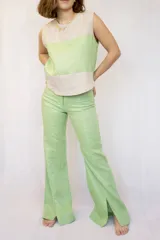 Pantalón de lino color verde claro, de corte recto y con aberturas en el ruedo.