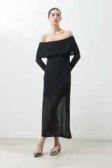 Vestido midi negro con escote bardot, mangas largas de tul y tajo lateral.