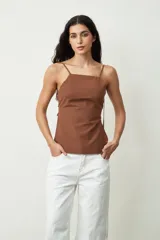 Musculosa marrón de breteles finos y corte ajustado.