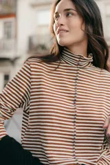 Polera de punto a rayas horizontales color celeste y blanco, de cuello alto y mangas largas.