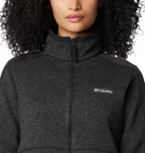 Campera polar Columbia Sweater Weather para mujer, color negro jaspeado, con cierre frontal completo, cuello alto, bolsillos laterales con cierre y logo bordado en el pecho.