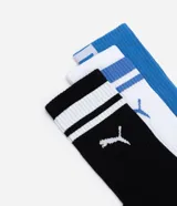 Kit de tres pares de medias deportivas Puma de caña larga. Un par color beige con dos rayas marrones horizontales en la parte superior y logo marrón en el tobillo. Un par color crema liso con logo blanco en el tobillo. Un par color marrón con una raya blanca horizontal en la parte superior y logo blanco en el tobillo.