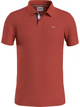 Chomba de diseño semiformal en color naranja, confeccionada en piqué de algodón orgánico, con corte slim y logo bordado de Tommy Jeans en el pecho.