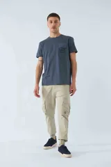 Pantalón cargo color marrón con corte slim, elástico en cintura y cordón ajustable, bolsillos cargo con botones y puños elásticos. Confeccionado en algodón y spandex.