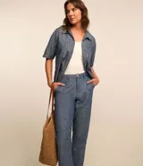 Pantalón recto de jeans azul con bolsillos y bajo plegado.