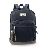 Mochila negra de tela Oxford con base de nobuk color marrón, dos bolsillos frontales con cierre y tiradores de cuero. Correas de hombro acolchadas.