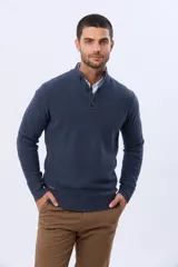 Buzo tejido color beige con textura, cuello alto con botones y manga larga.