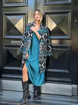 Chaquetón con estampado geométrico en tonos azul, negro y blanco, confeccionado en 50% lana y 50% poliéster.