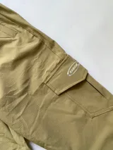 Pantalón cargo color beige con bolsillos laterales y logo de la marca Kaboa en la solapa de uno de los bolsillos.