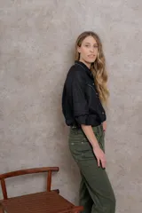 Camisa blanca de lino con cuello tipo masculino, abotonadura central, manga larga y puños con botones. Canesú y cuello bordado con cadeneta roja.