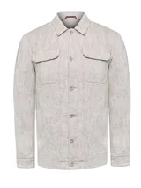 Chaqueta color arena confeccionada en lino con efecto melange. Tiene cuello camisero, cierre con botones, cuatro bolsillos frontales y bolsillos interiores.