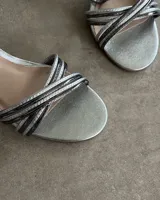 Sandalias plateadas con tiras finas cruzadas y taco de 7 cm.