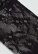 Medias de nailon negras con diseño de encaje floral.