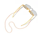 Correa para lentes con cuentas redondas color naranja, enganches dorados y terminales de silicona transparente. Incluye un dije dorado con el logo de la marca.