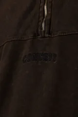 Buzo negro de frisa 100% algodón con medio cierre y bordado al tono. Tiene un lavado snow que le da un look gastado.