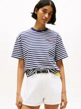 Remera de algodón a rayas horizontales azules y blancas, con cuello redondo azul y logo de Tommy Hilfiger en el pecho.