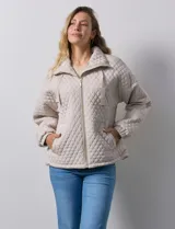 Campera beige capitoneada marca Weatherproof, con cierre central, bolsillos delanteros y forro interno.