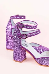 Zapatos de tacón color lila con glitter, punta redondeada y doble tira con hebilla en el tobillo.