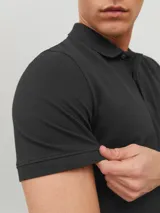 Chomba negra de piqué con cuello clásico, manga corta y calce slim fit.