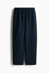 Pantalón tobillero azul marino de corte holgado en tejido liviano de mezcla de lino. Modelo de tiro alto con elástico revestido y cordón para ajustar fino en la cintura, bolsillos al bies y piernas ajustadas.