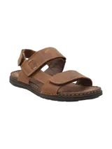 Sandalias marrones de cuero con tiras ajustables con velcro y suela de goma.