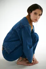 Chaqueta de jean azul con cuello de pana color camel, corte recto y bolsillos frontales.