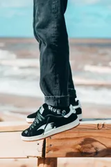 Championes negros de gamuza con detalles en blanco, suela blanca con base color caramelo y cordones negros.